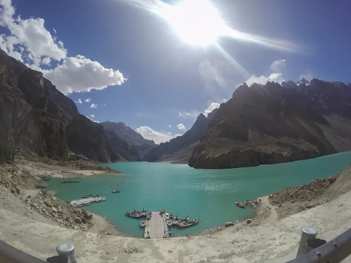 Attabad Lake in Gojal, Hunza, with turquoise water, the boat jetty and bare brown mountains in bright sunshine