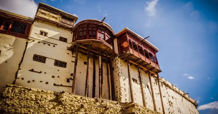 Baltit Fort in Karimabad, Hunza, its whitewashed walls and carved wooden balconies above the stone plinth, Gilgit-Baltistan
