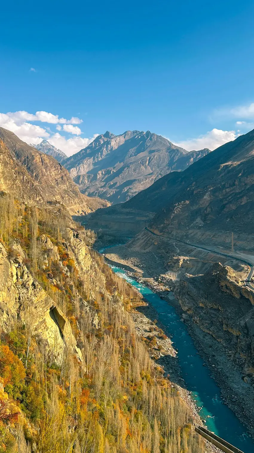 The milky turquoise glacier-fed Hunza River winding through the gorge below Karimabad in autumn, Gilgit-Baltistan