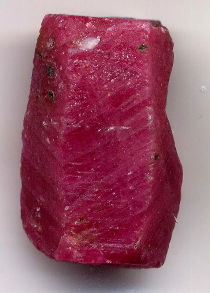 A rough red ruby crystal (red corundum), the kind of gemstone mined in the Hunza Valley of Gilgit-Baltistan