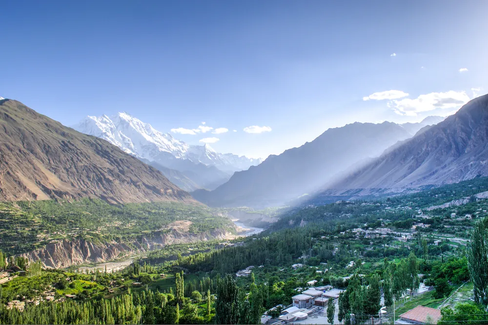 Terraced fields and villages of the Hunza Valley below snow-capped Karakoram peaks in northern Pakistan