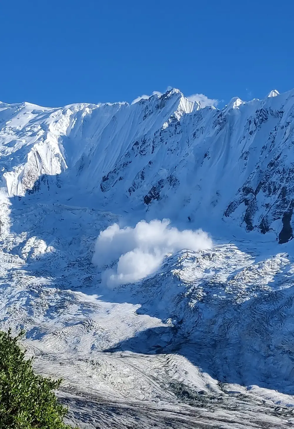 Powder avalanche breaking down the snow face above the Minapin Glacier, Nagar Valley