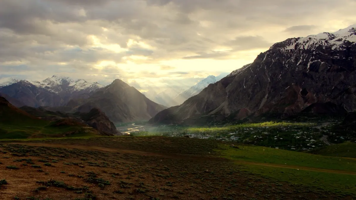 Sunrise seen from the edge of Qaqlasht Meadows looking down over the Booni valley and river in Upper Chitral, Pakistan