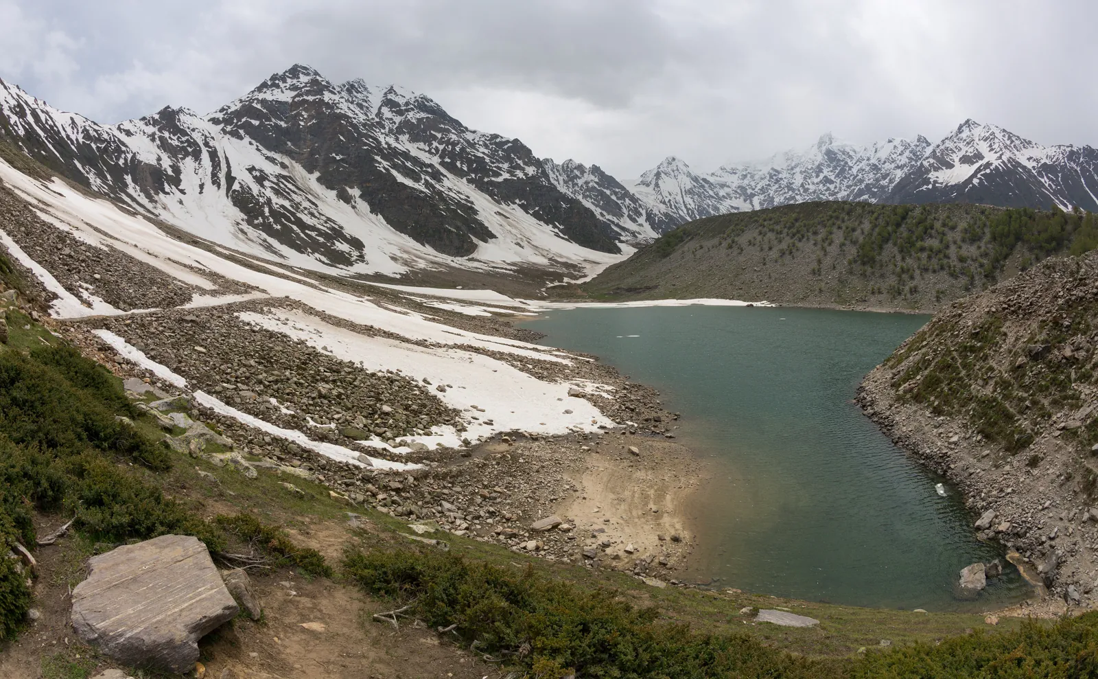 Rama Lake in the Astore Valley below snow-streaked ridges and moraine on the Nanga Parbat side