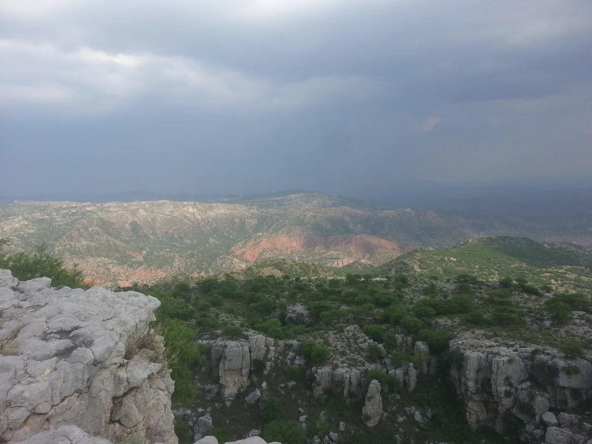 Red eroded hills and limestone cliffs of the Salt Range seen from Malot, Chakwal District, Punjab, Pakistan
