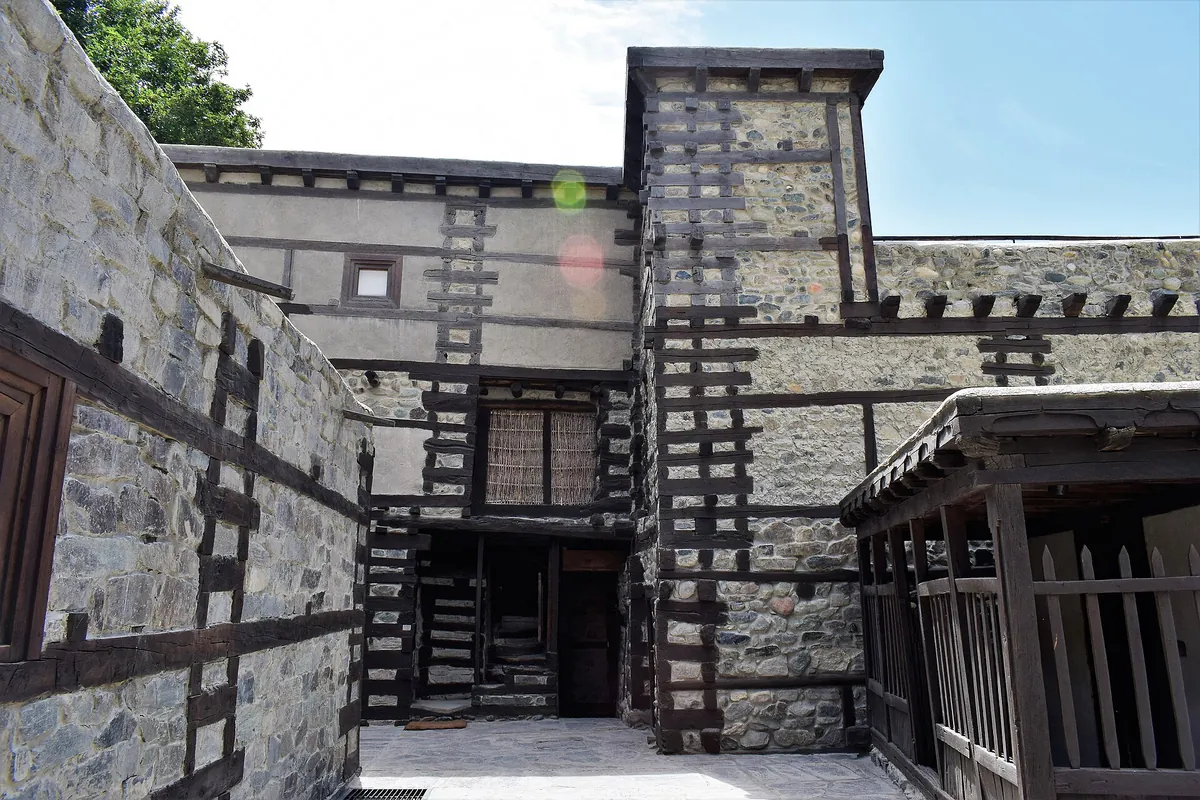 Restored Shigar Fort near Skardu, with timber-laced stone walls and carved wooden windows in its courtyard