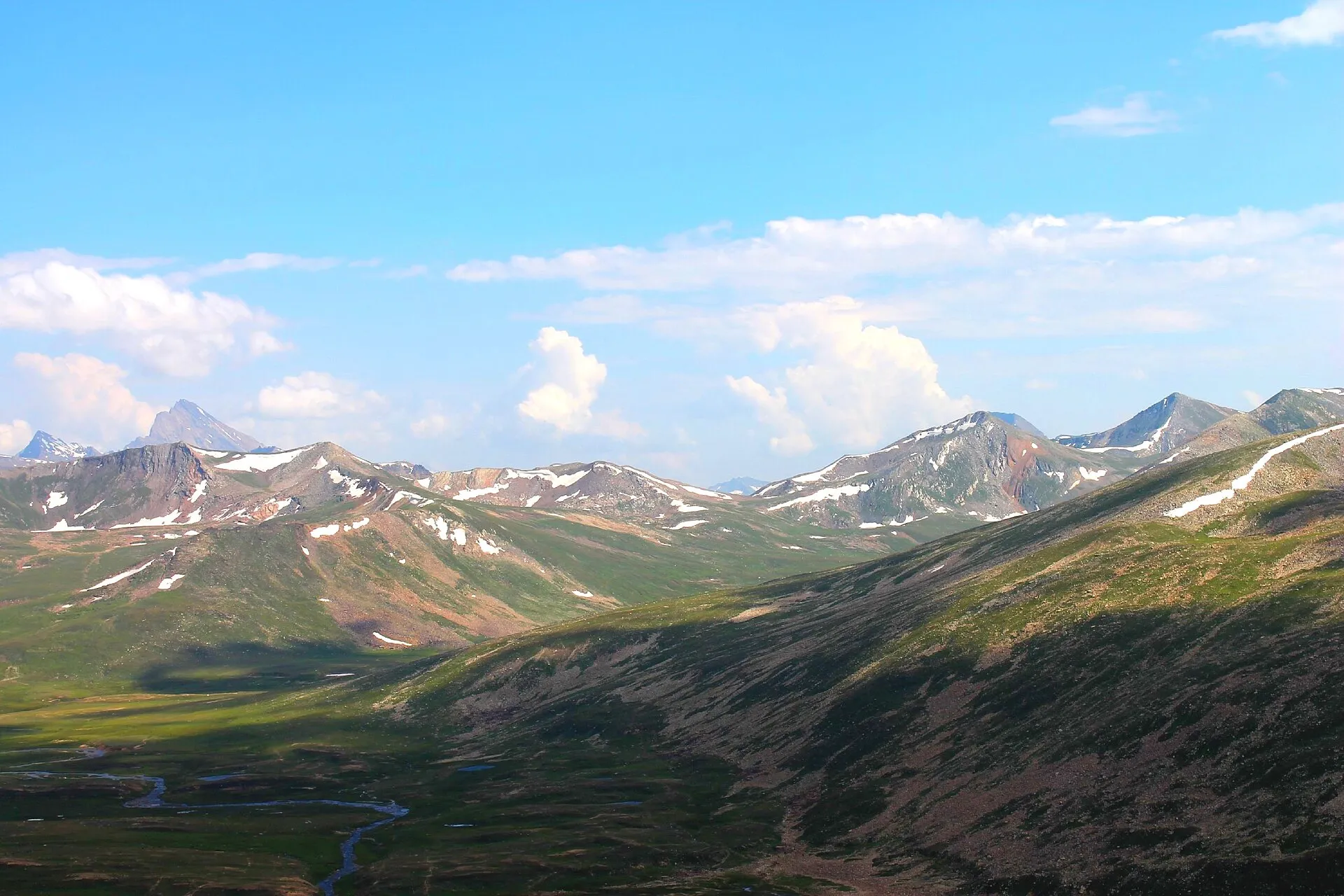 The green Babusar valley below snow-capped peaks