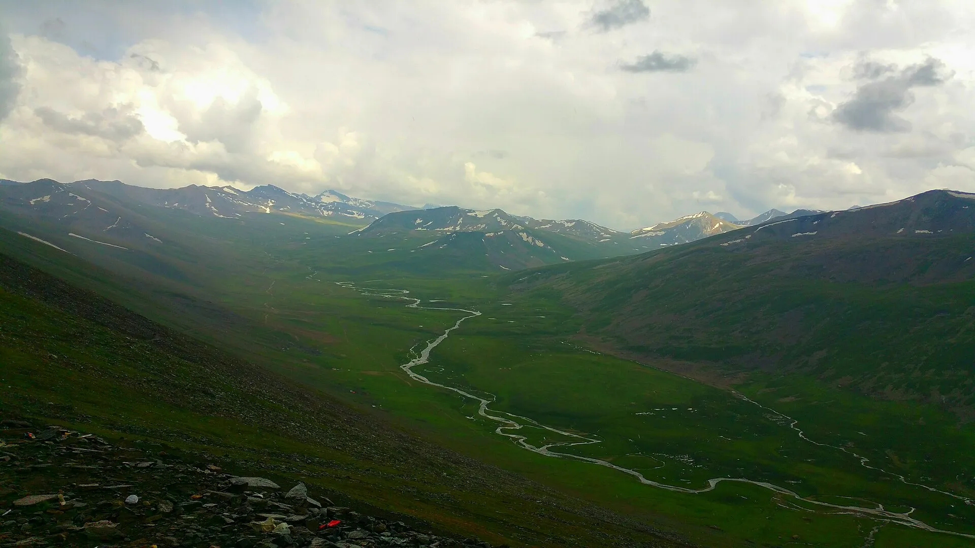 A river winding through the green valley below Babusar Pass