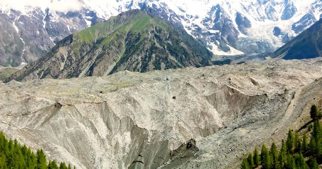 The Barche glacier and Diran peak above the summer meadows of upper Bagrote Valley near Hopay