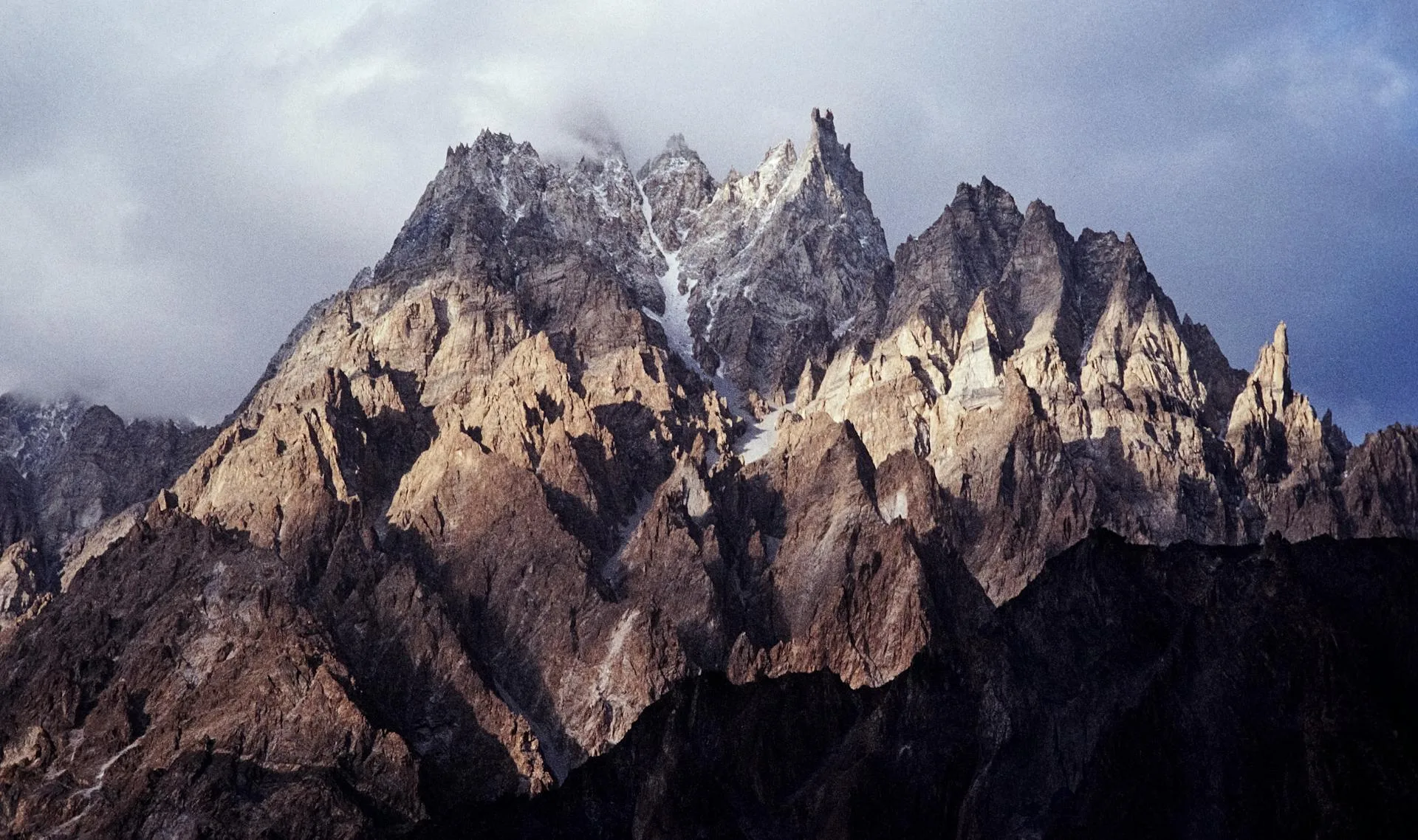 Sunset over a snow-covered mountain near a body of water