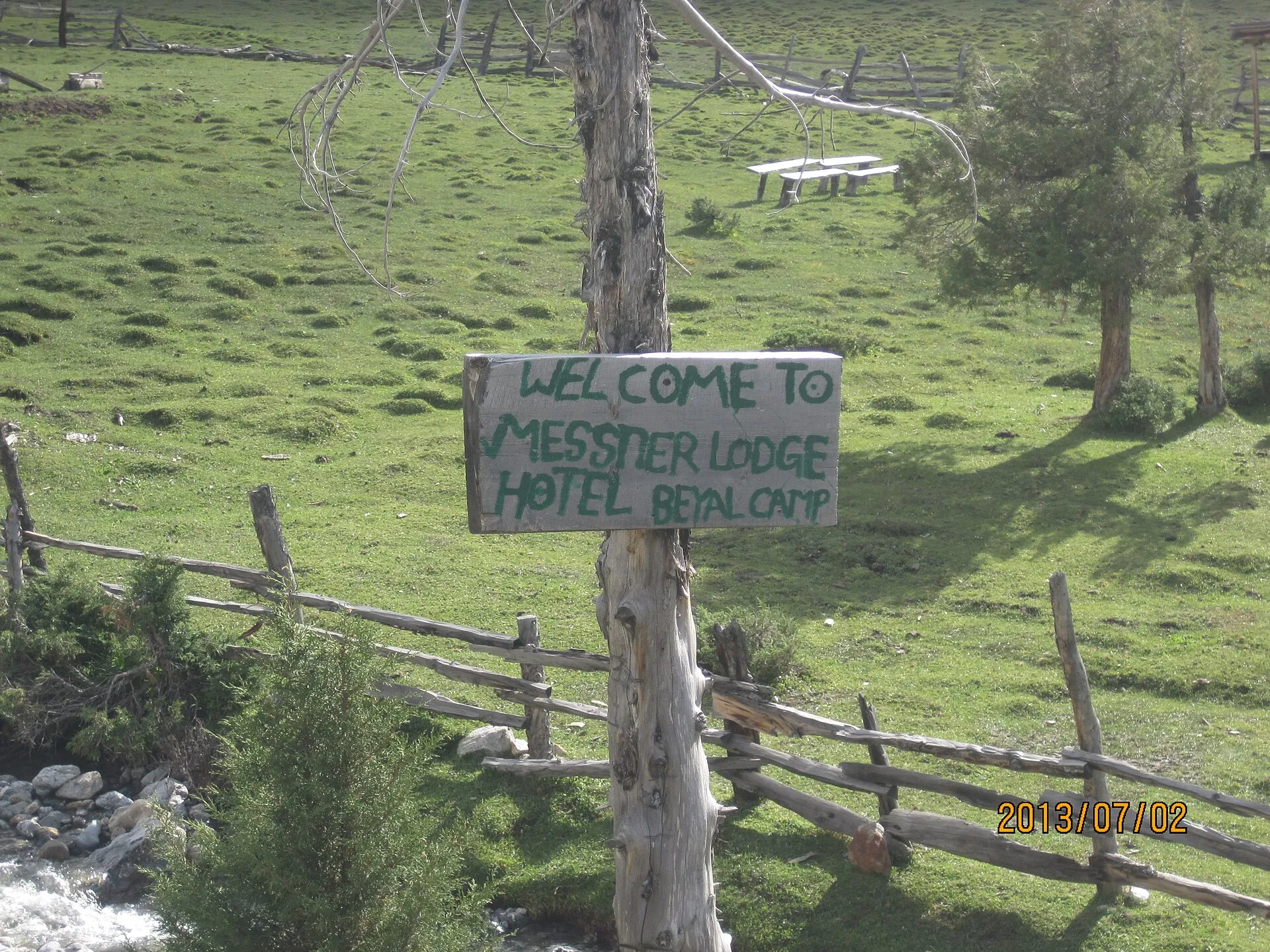 The green meadow and lodge sign at Beyal camp near Fairy Meadows