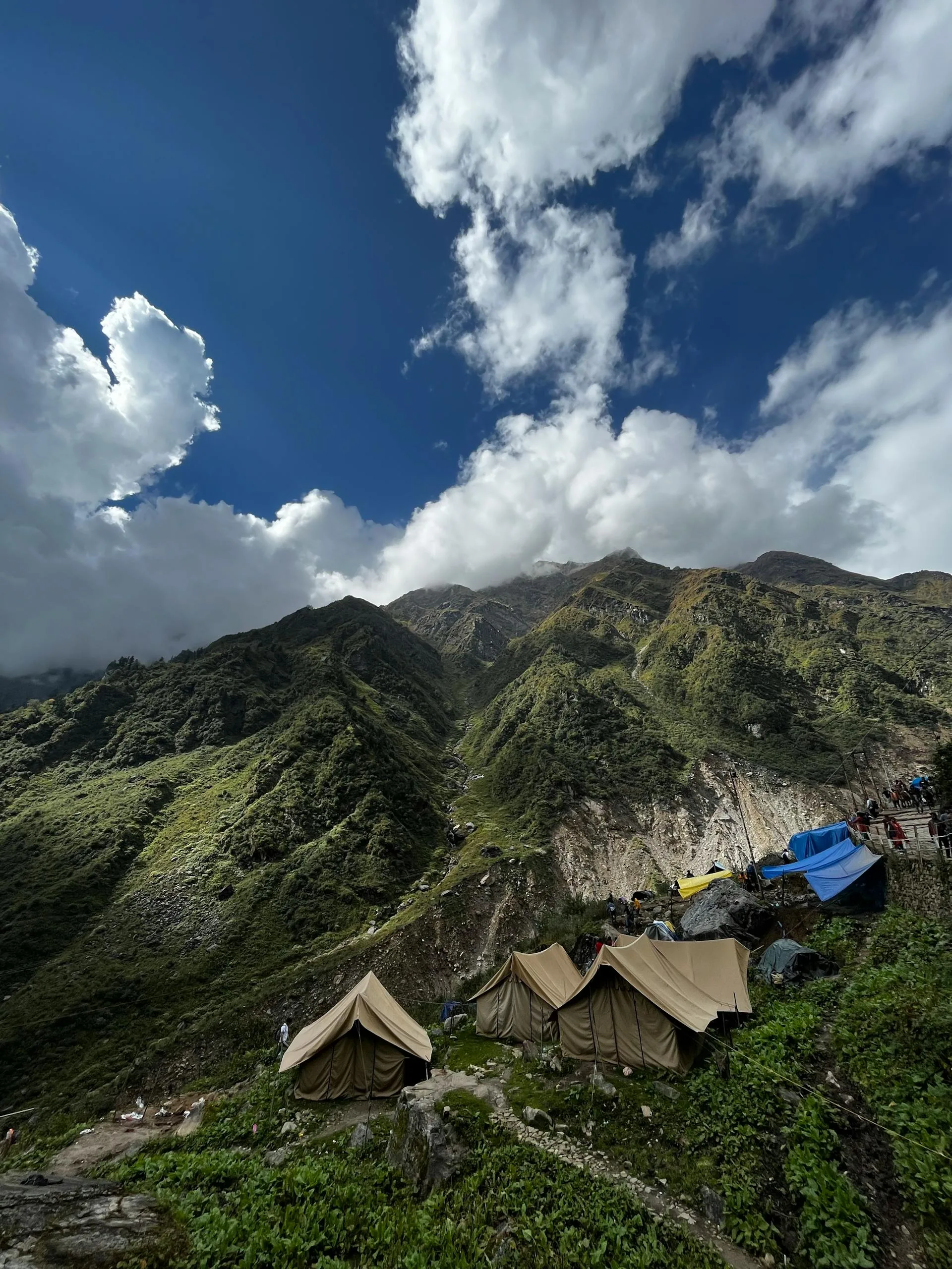 Camping tents on mountain under blue sky
