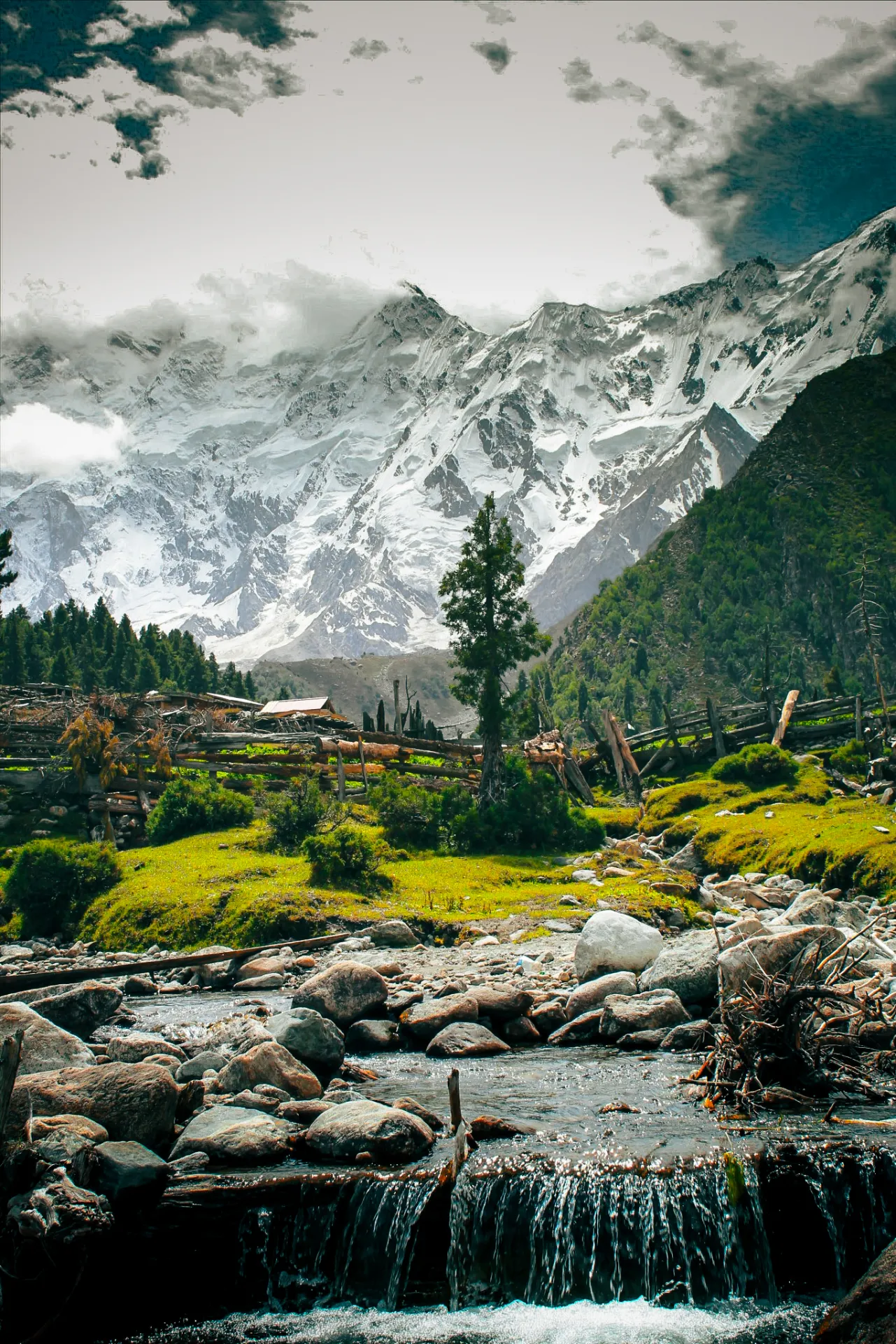 A stream cascading through Fairy Meadows with Nanga Parbat rising behind