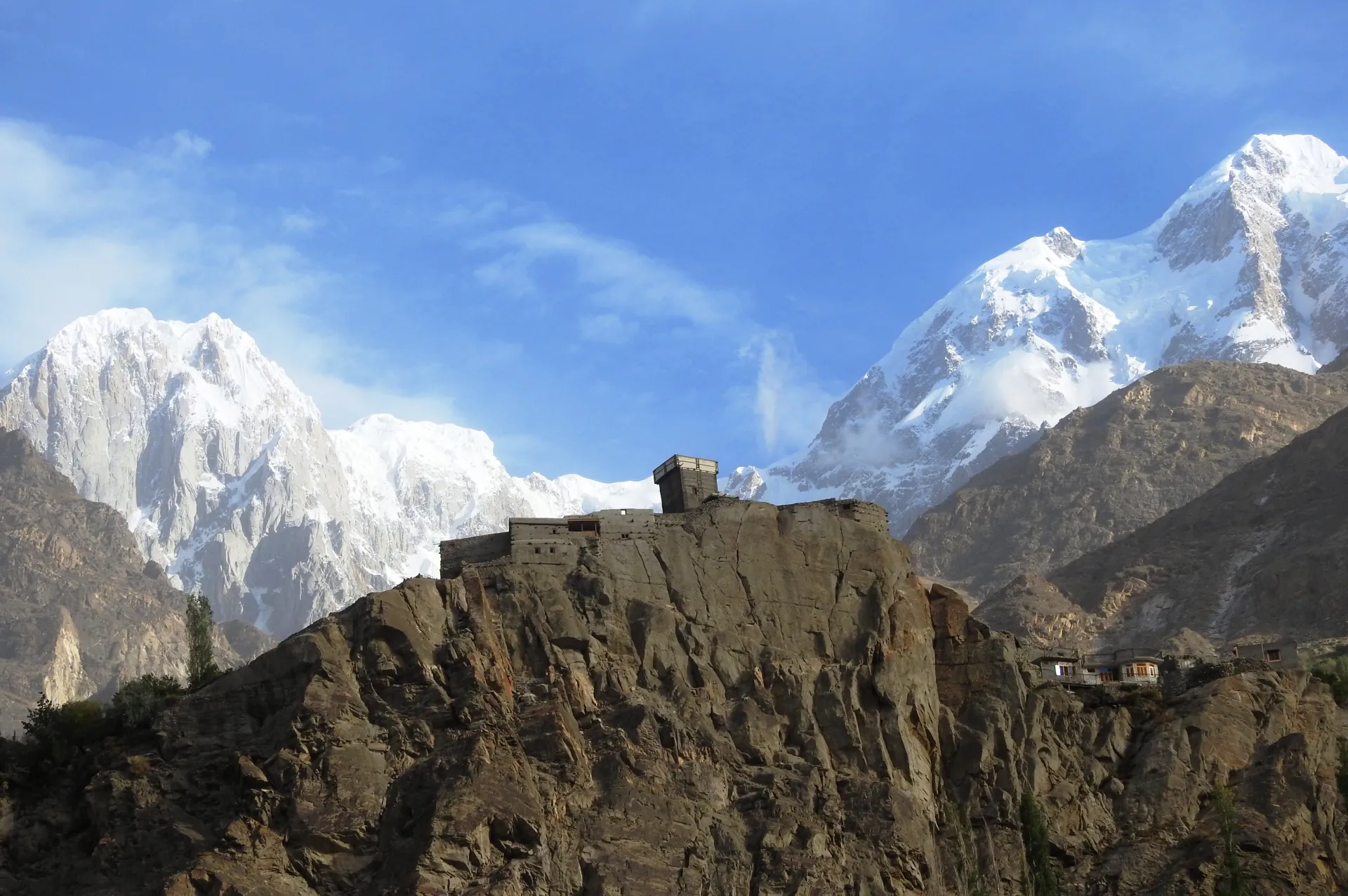 Altit Fort above the Hunza River with snow peaks behind