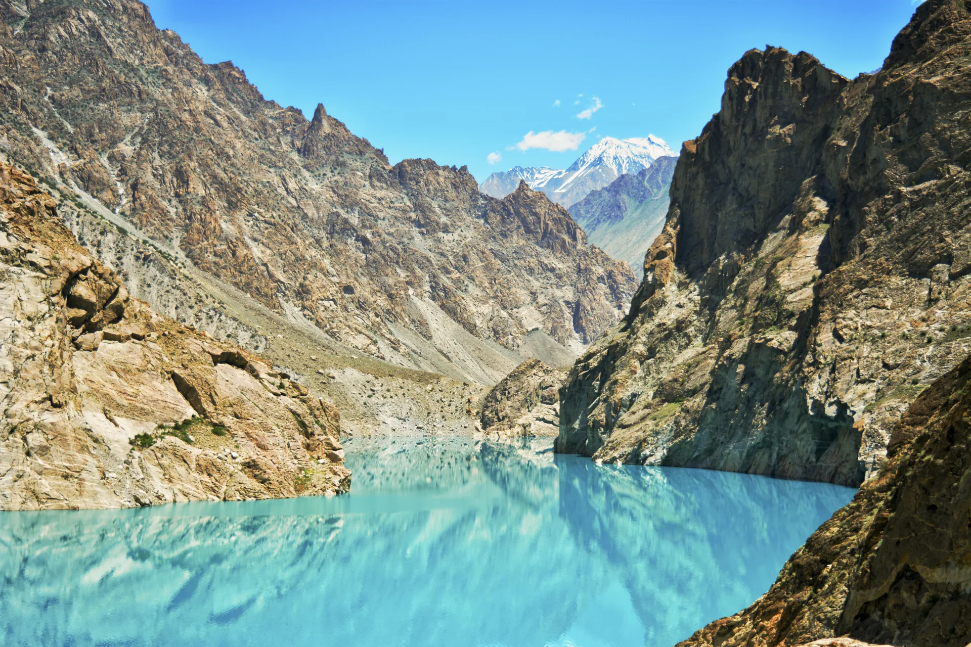 Mother and children by a lake on a family holiday in Hunza Valley, northern Pakistan