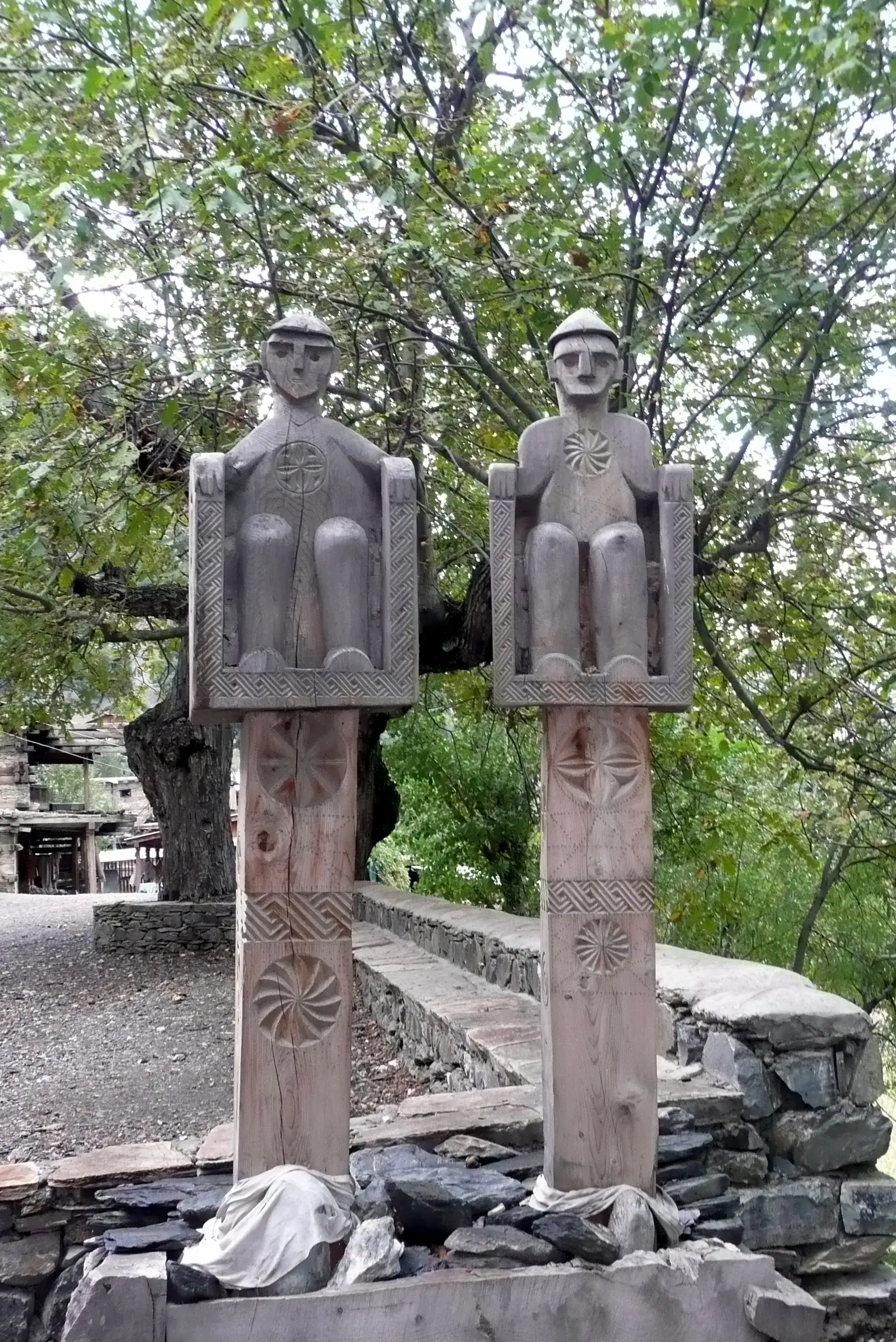 Carved wooden guardian effigies in a Kalash village in Bumburet, Chitral
