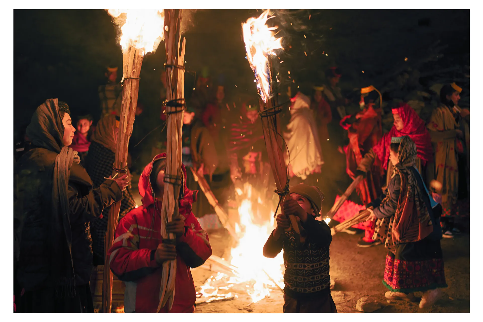 Kalash people carrying flaming torches at the Chowmos winter solstice festival