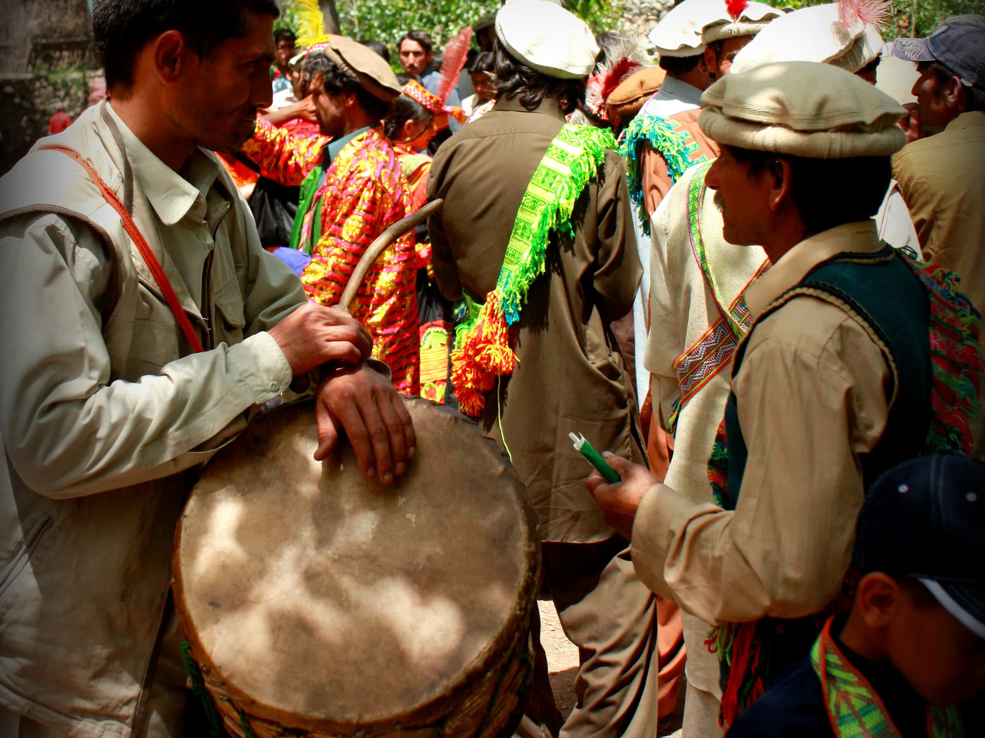 Kalash musicians drumming during a festival procession in Bumburet valley