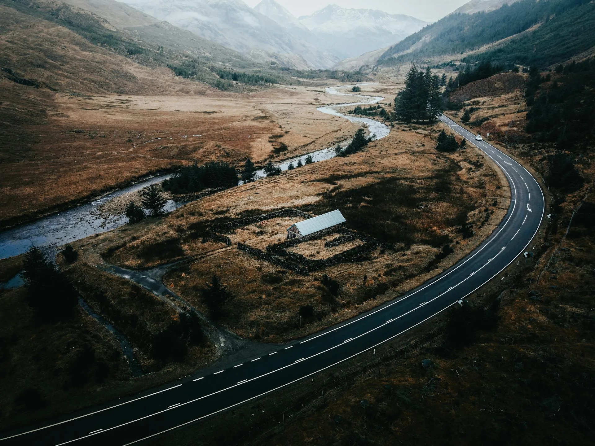 Aerial view of highway between mountain ranges