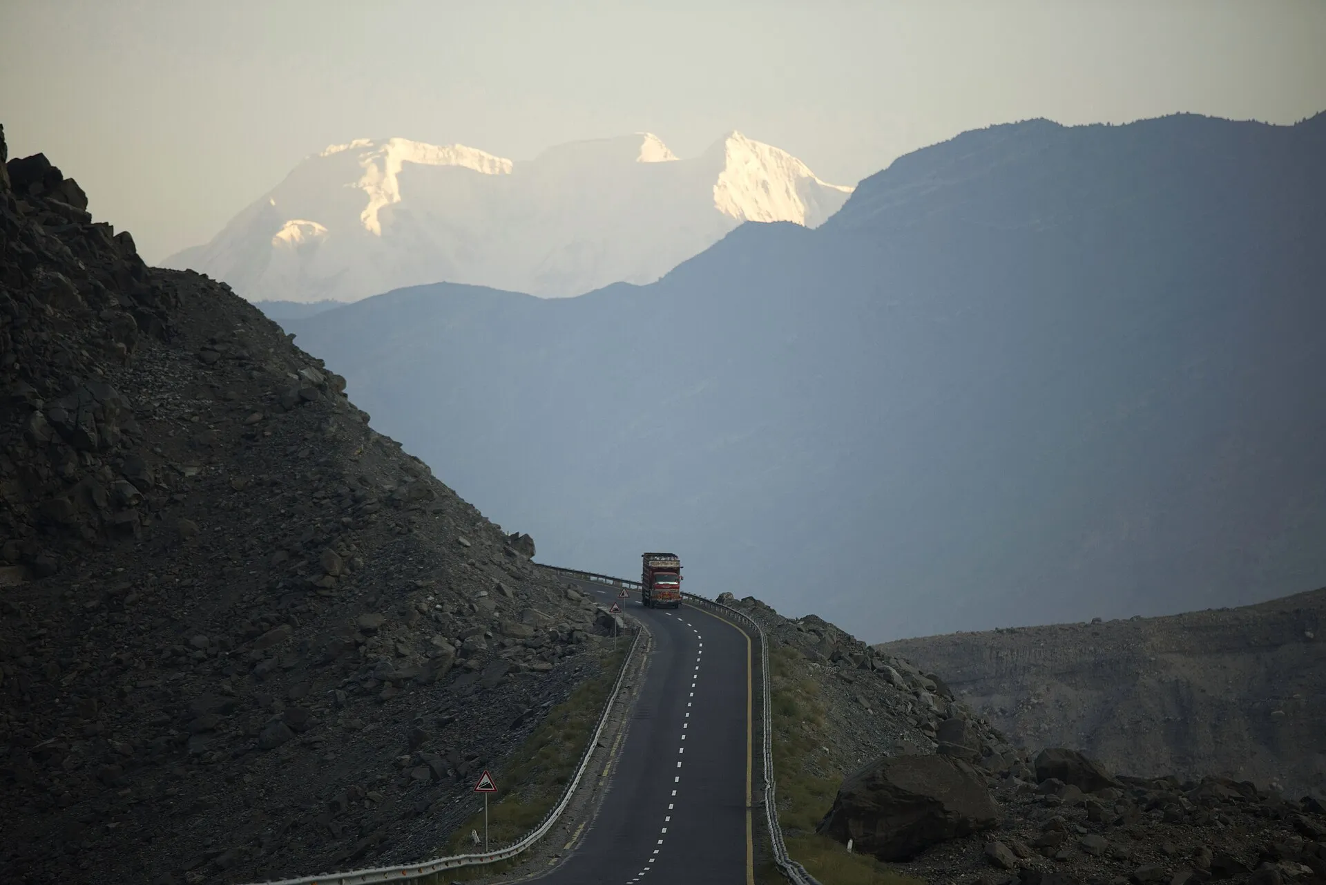 A truck on a cliff section of the Karakoram Highway
