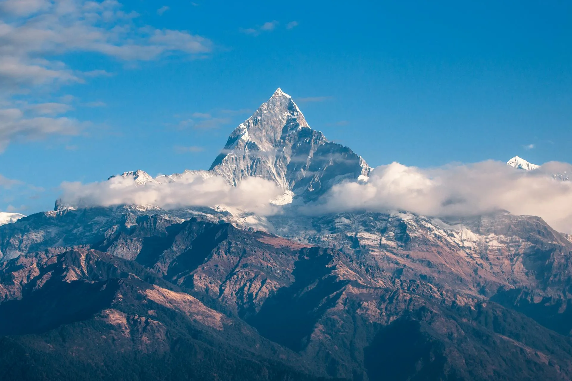 A rugged gray and brown mountain face
