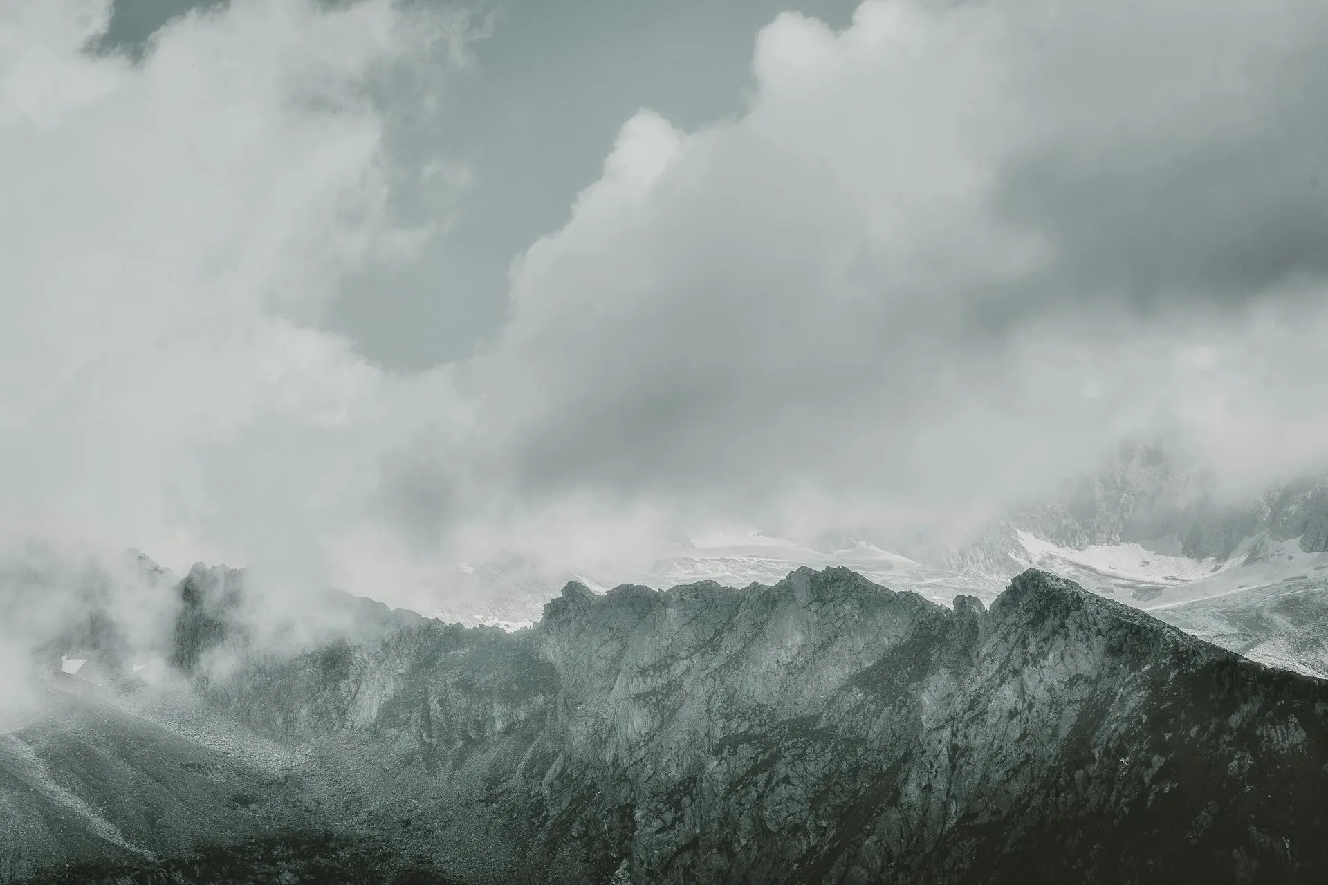 Jagged mountain peaks shrouded in clouds