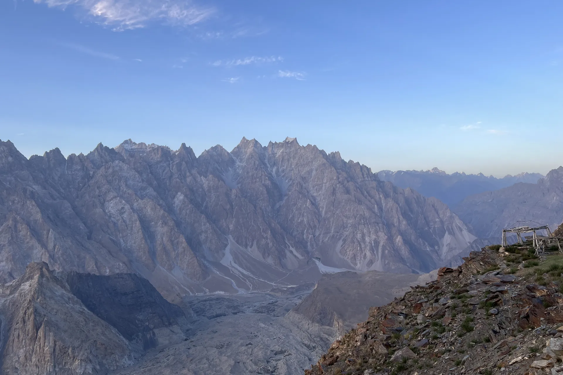 The serrated ridge of Tupopdan (Passu Cones) above the Passu Glacier, seen from Patundas Meadows at dawn