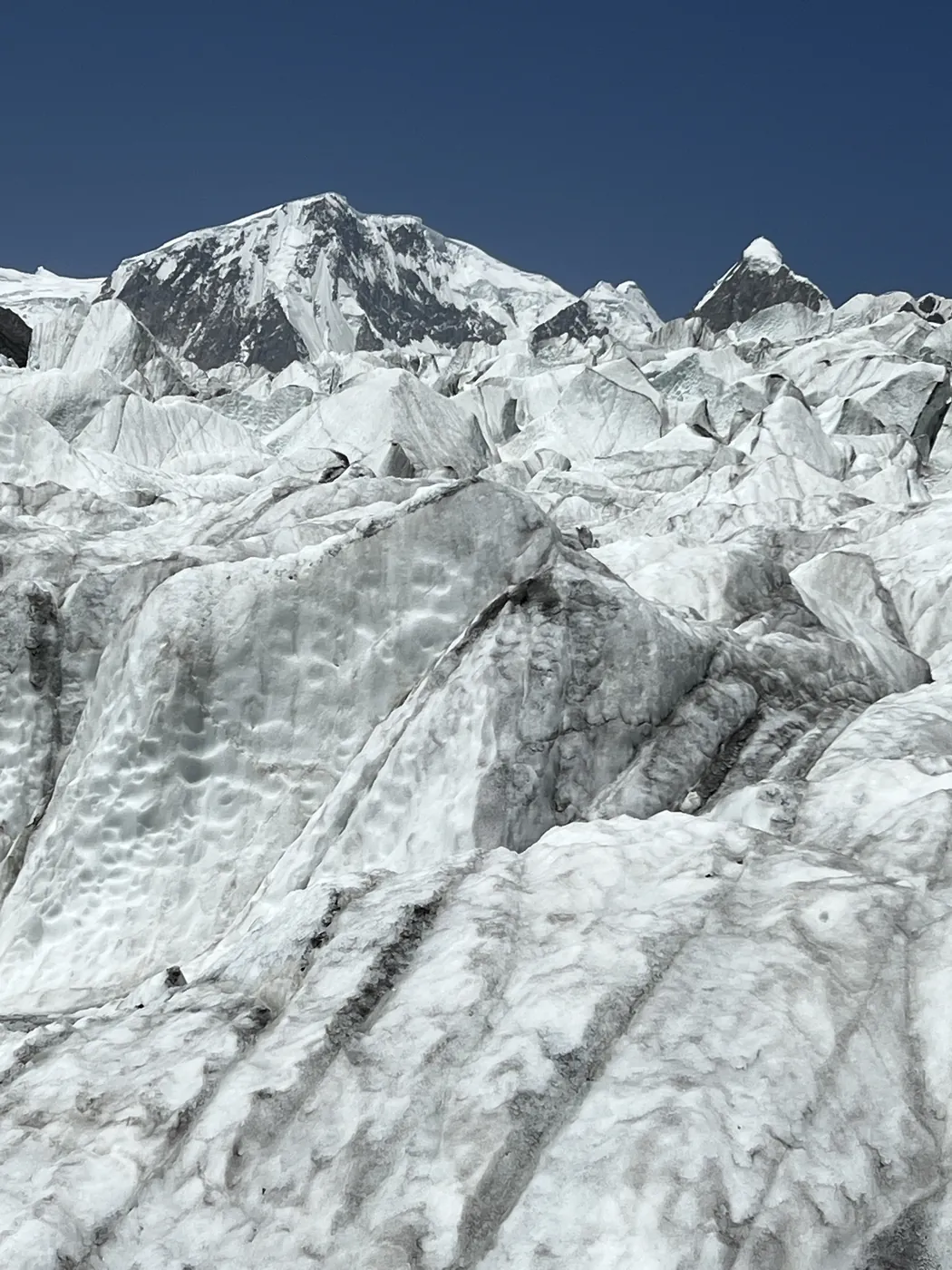 Ice seracs on the Passu Glacier below a snow-covered Karakoram peak, Patundas Meadows trek