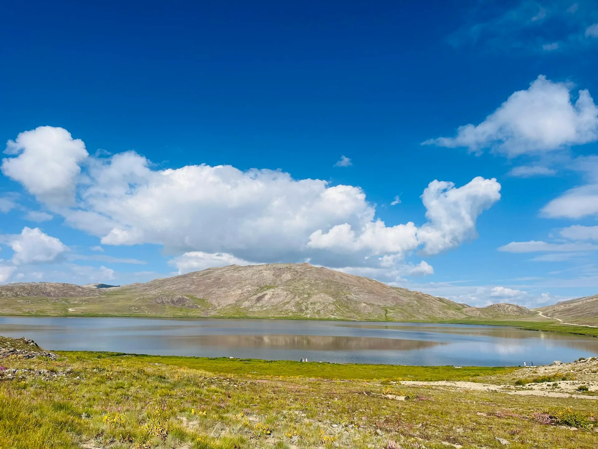 A stunning alpine lake reflecting the surrounding mountains