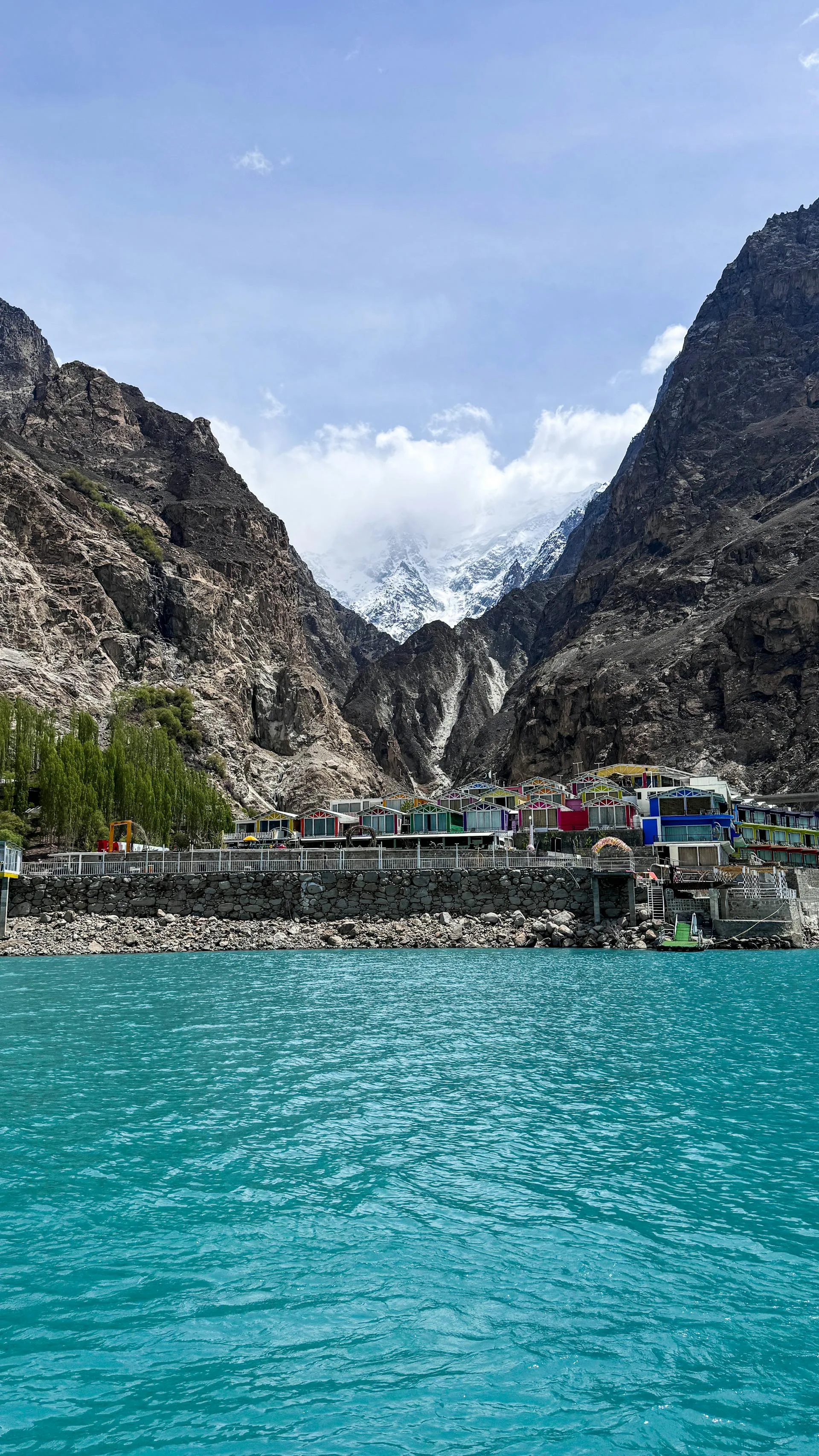 A pristine lake with a snow-capped mountain in the background