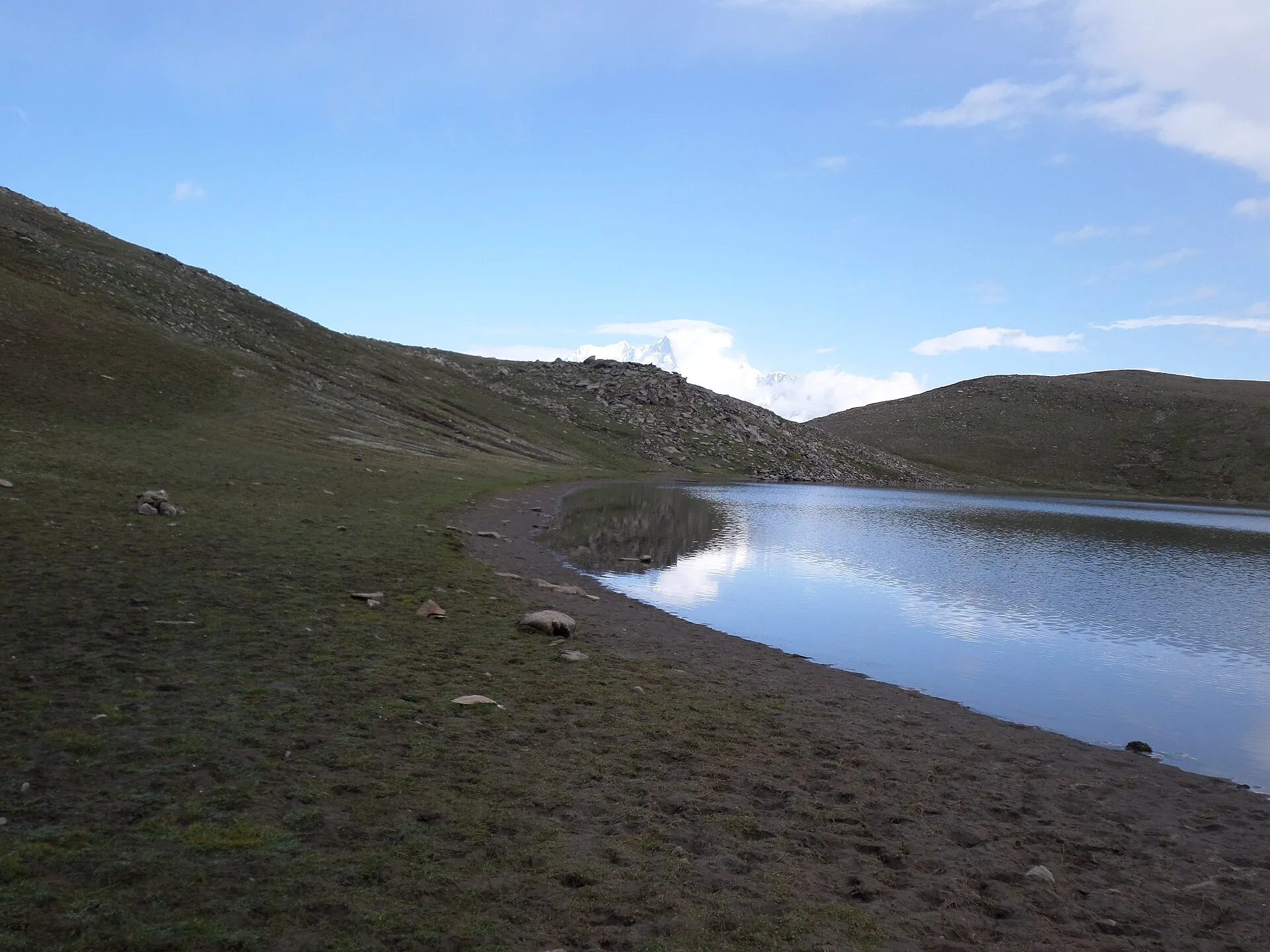The still water of Rush Lake beneath the Nagar peaks