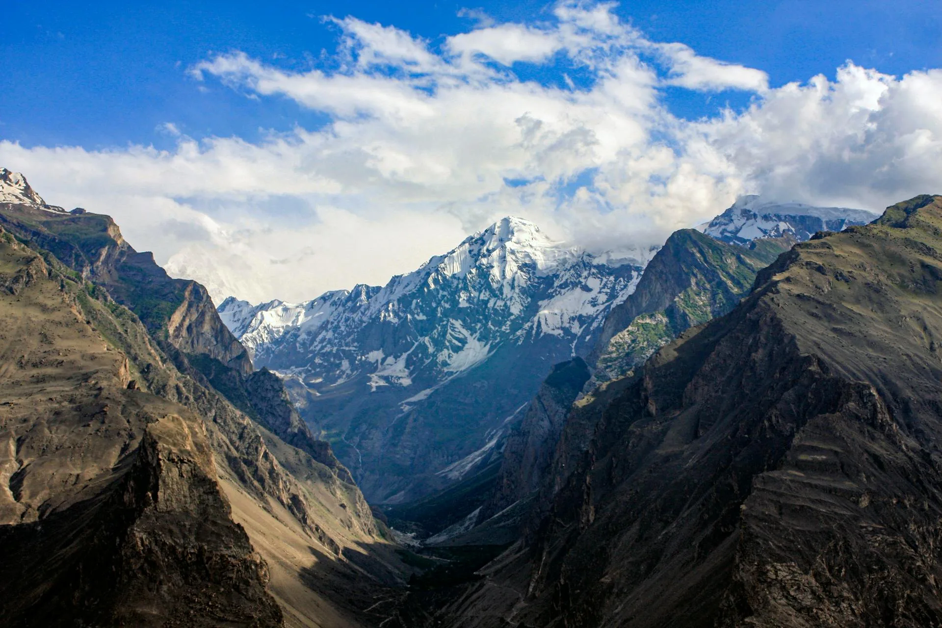 Snow-coated rocky mountains along the Hispar Glacier