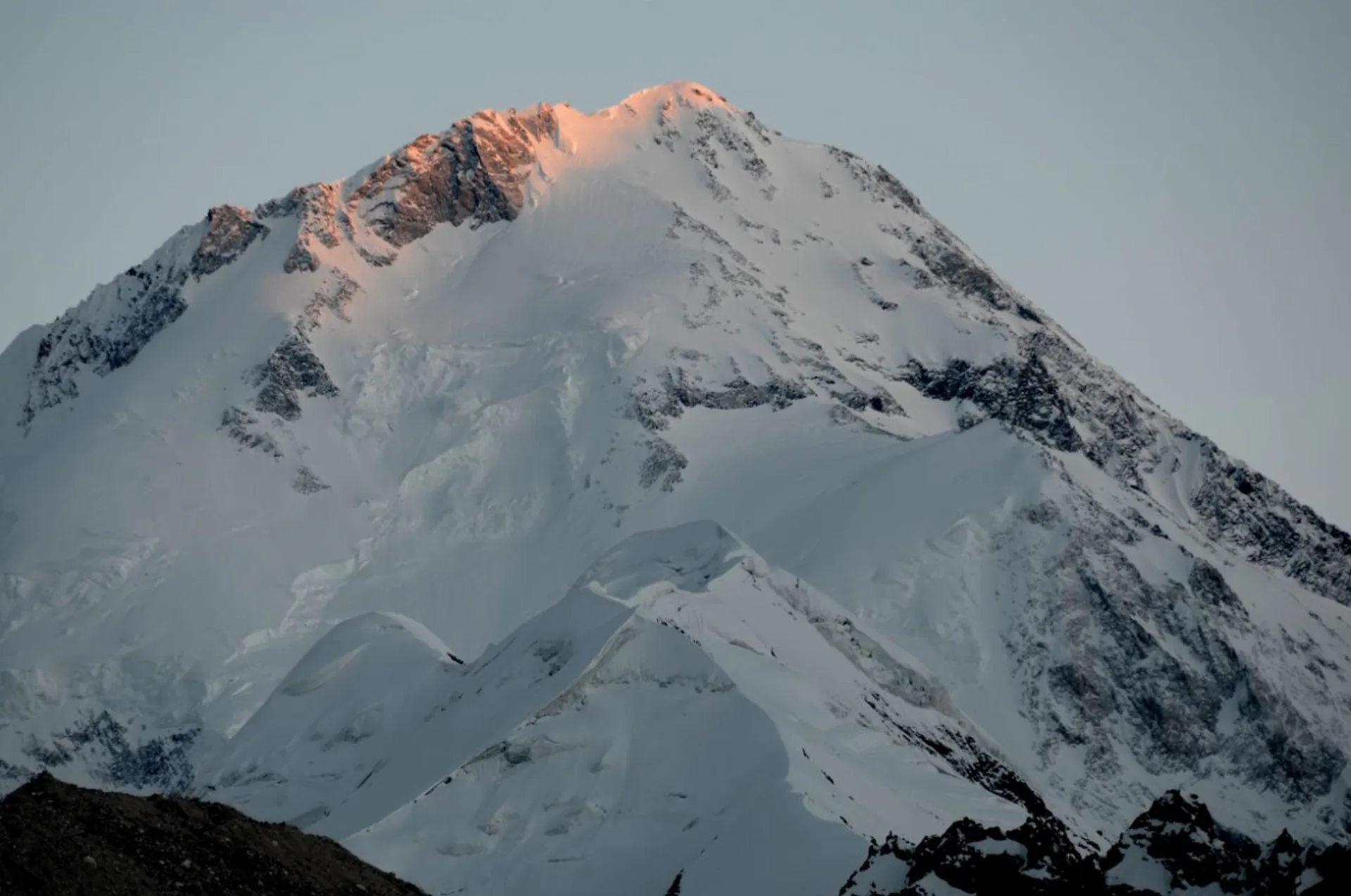 Gasherbrum I summit alpenglow at end of sunset with pink light on snow, 8080m Karakoram Pakistan