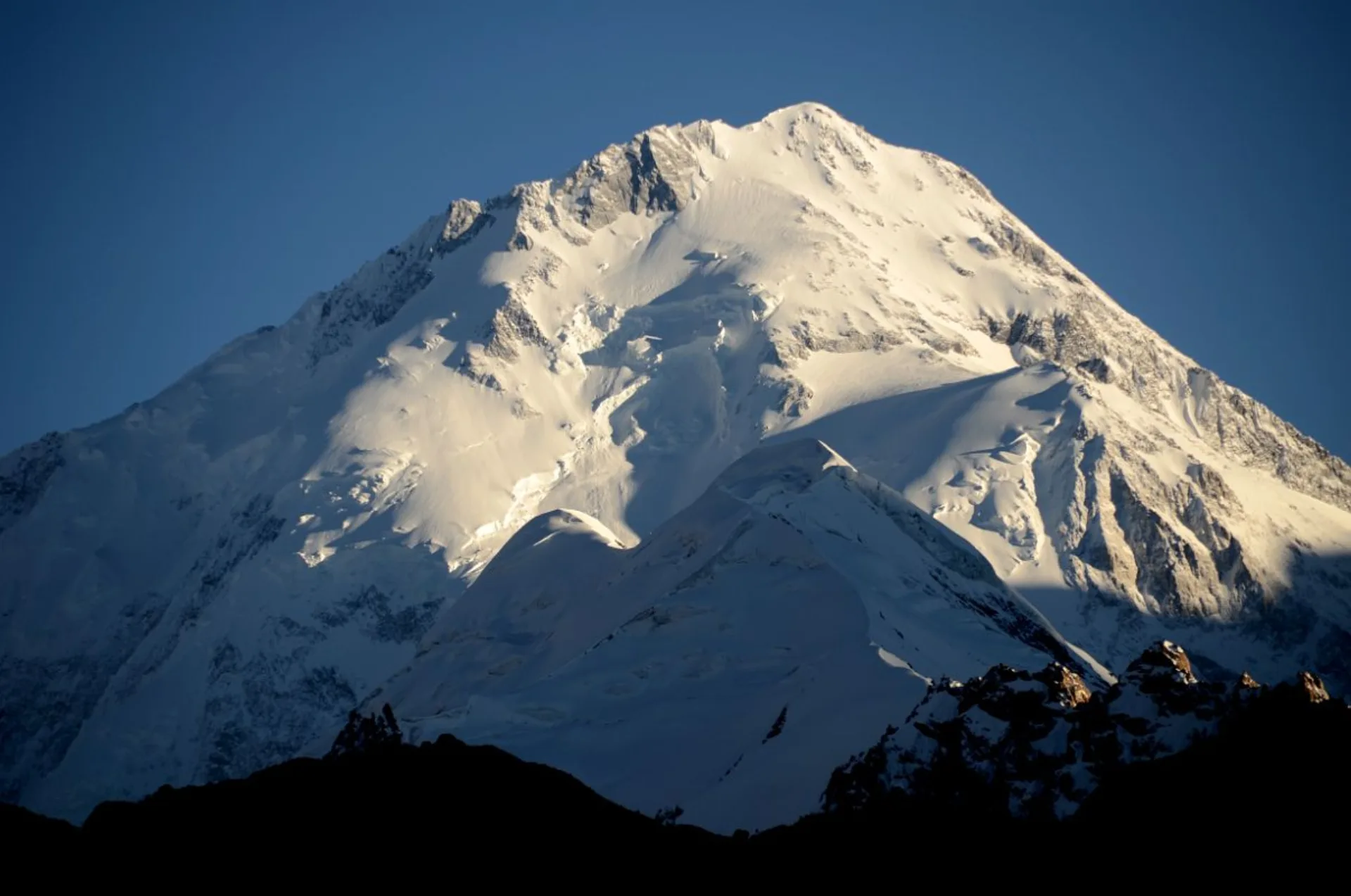 Gasherbrum I Hidden Peak north face illuminated before sunset with snow ridges and glaciers