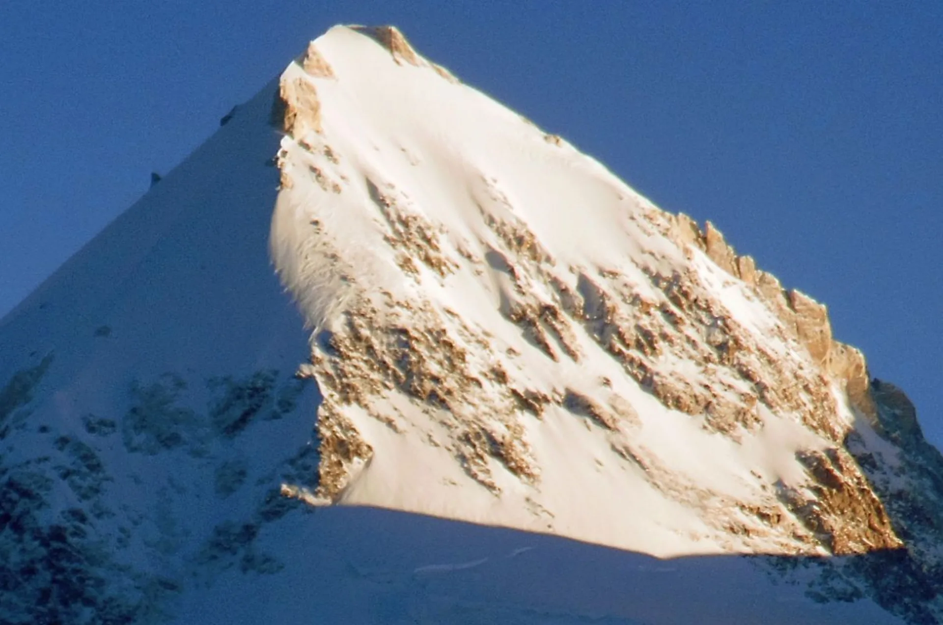 Gasherbrum II 8035m summit pyramid close-up bathed in golden light just before sunset