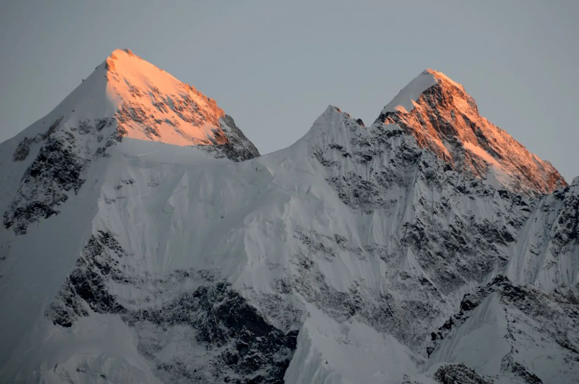 Gasherbrum II and Gasherbrum III north faces glowing red-orange at sunset, 8035m Karakoram Pakistan