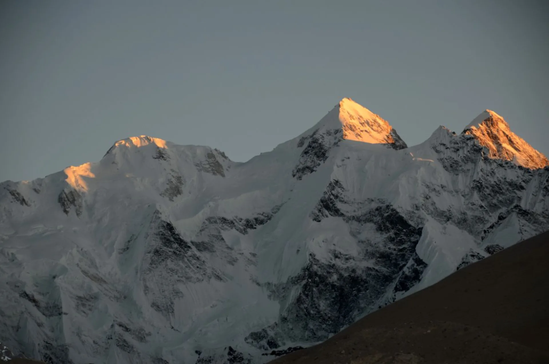 Gasherbrum II E, Gasherbrum II and Gasherbrum III triple peaks with golden sunset light on summits